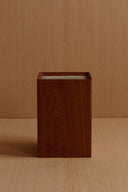 A front-facing view of the wooden box, highlighting its rectangular shape and vertical wood grain.